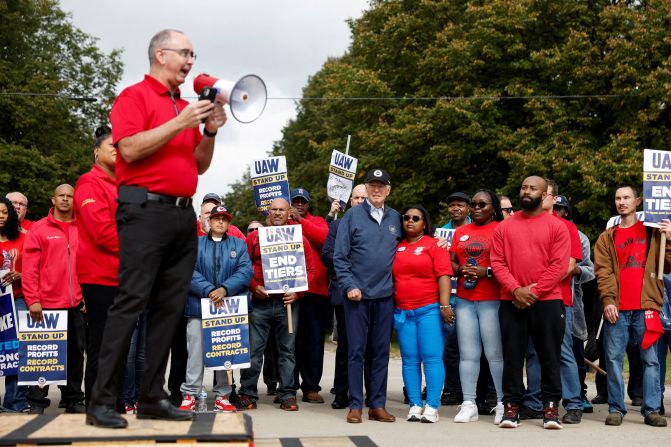 Shawn Fain, president of the United Auto Workers, speaks as Biden, center, joins <a href="https://www.cnn.com/2023/09/26/politics/biden-picket-line-michigan-uaw/index.html" target="_blank"