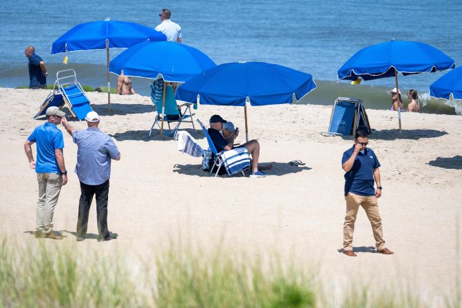 Biden and the first lady sit under an umbrella at Rehoboth Beach in Delaware in August 2023.