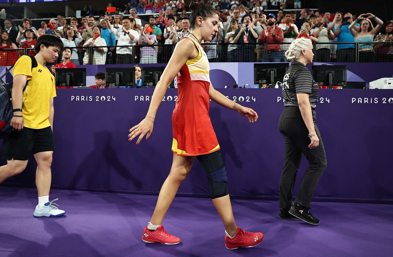 Carolina Marin of Spain leaves the court after retiring from the match against Bing Jiao He of China in the women's singles badminton semifinals on August 4. 