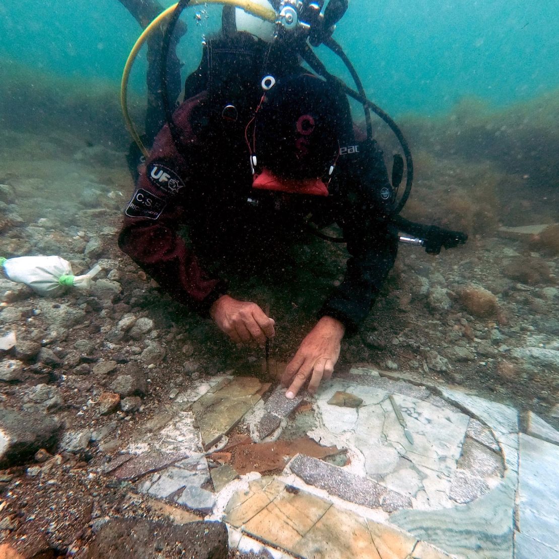 A diver works on the submerged mosaic floor.