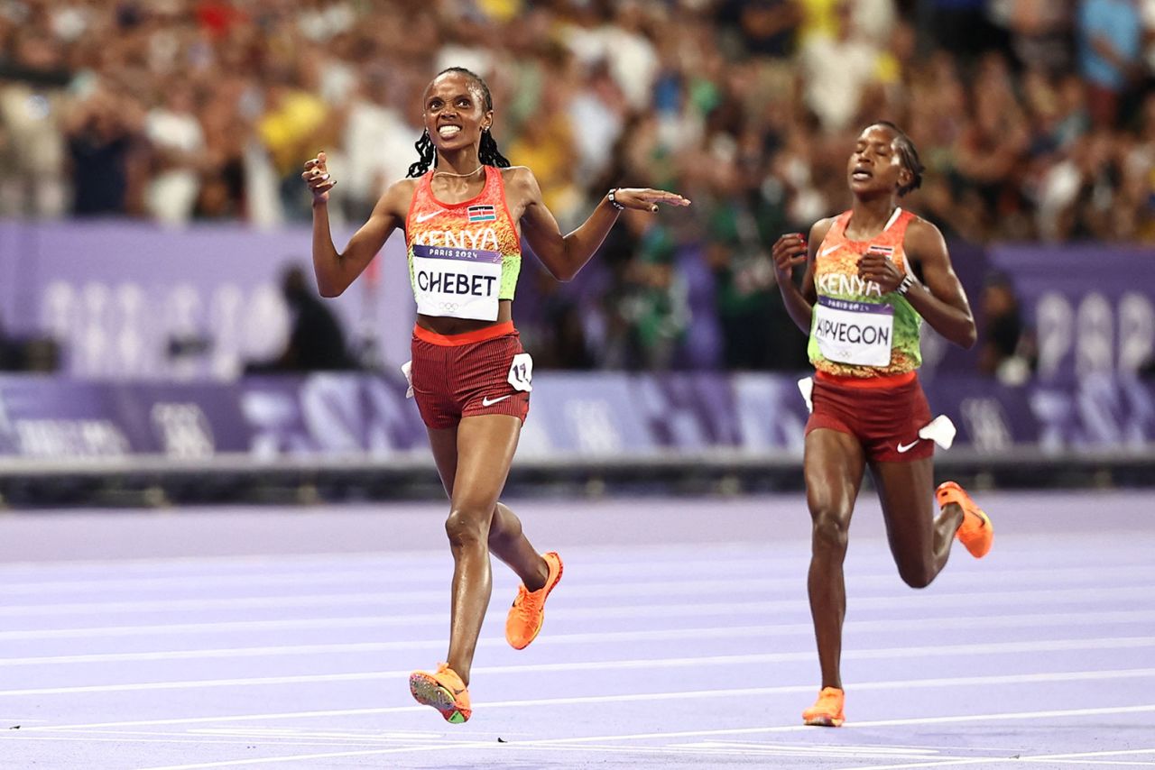 Kenya's Beatrice Chebet crosses the finish line ahead of Kenya's Faith Kipyegon in the women's 5000m final.