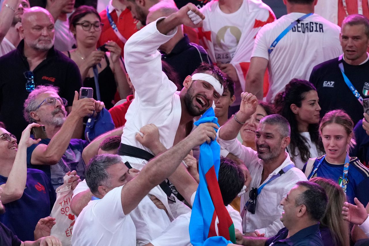 Azerbaijan's Zelym Kotsoiev celebrates after defeating Georgia's Ilia Sulaimanidze on Thursday.