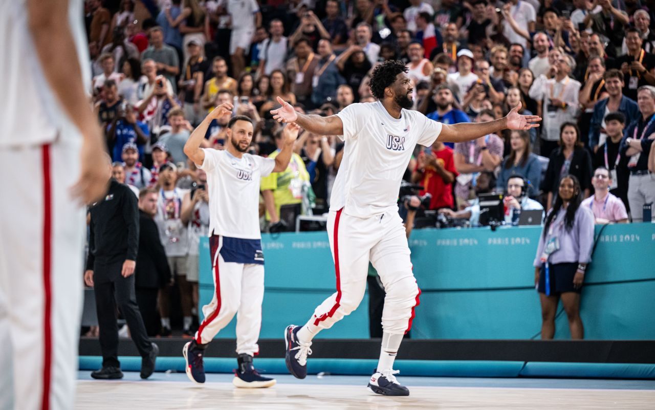 Joel Embiid, center, and Stephen Curry of team USA walk onto the court before their game against Brazil, in Paris, on August 6.