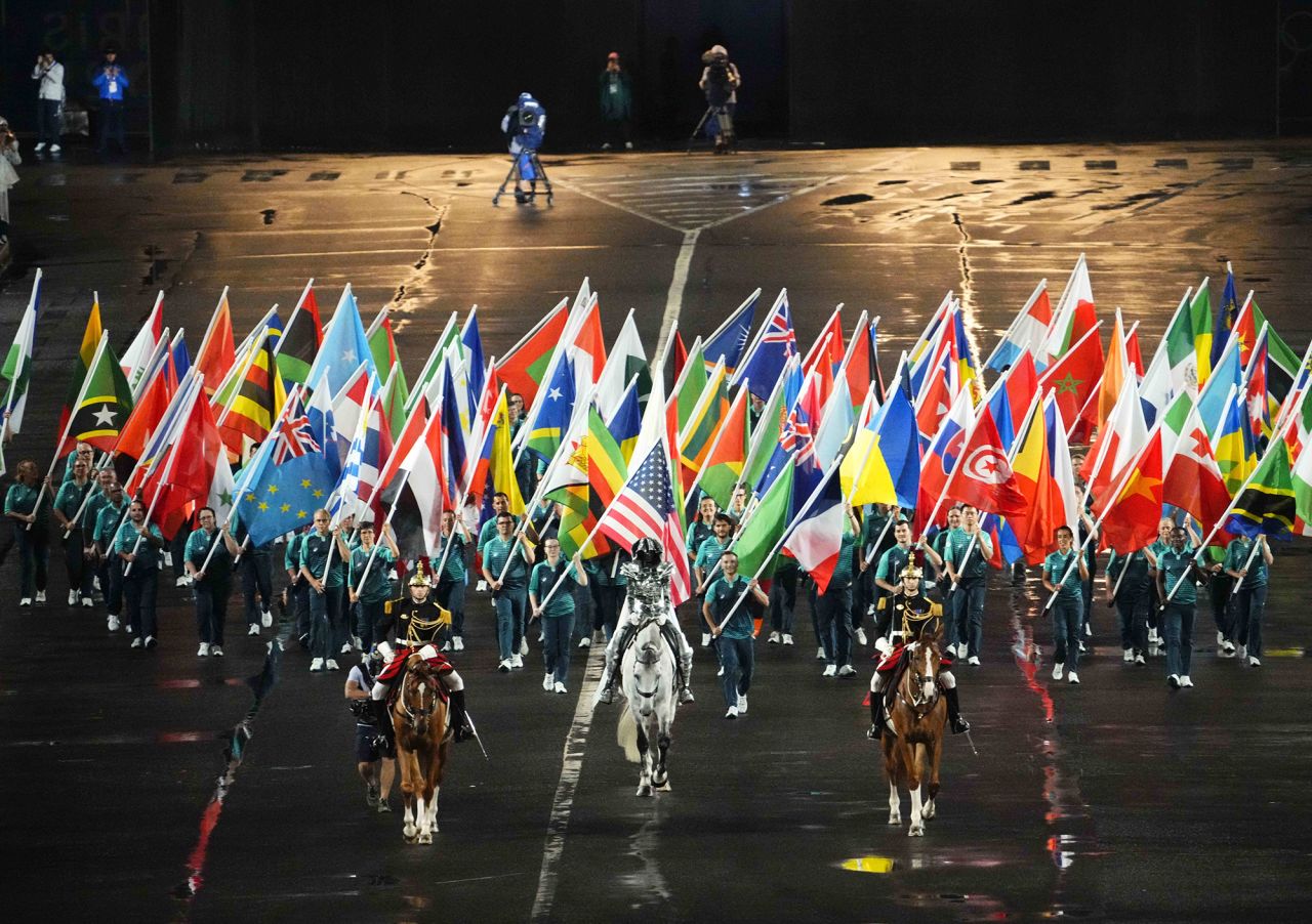 The Olympic flag is carried into the Trocadero by Floriane Issert.