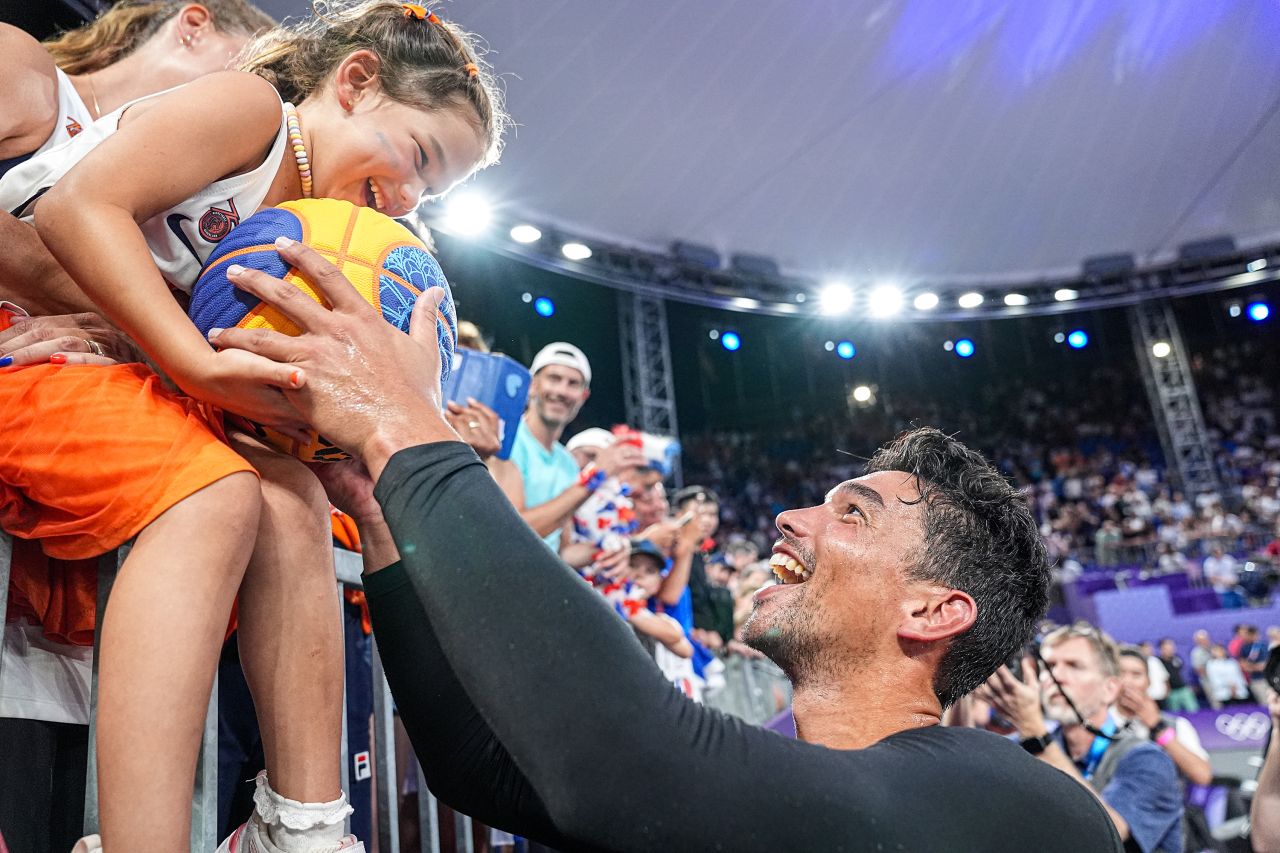 A fan receives a signed ball from Arvin Slagter of the Netherlands after his 3x3 basketball team dramatically won gold on August 5.