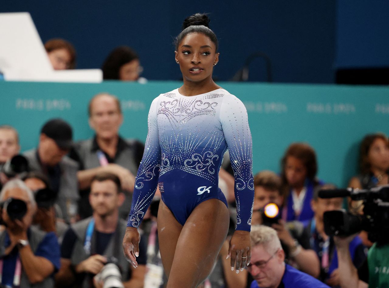 Simone Biles of United States reacts after falling off during her performance in the women's balance beam final on August 5.