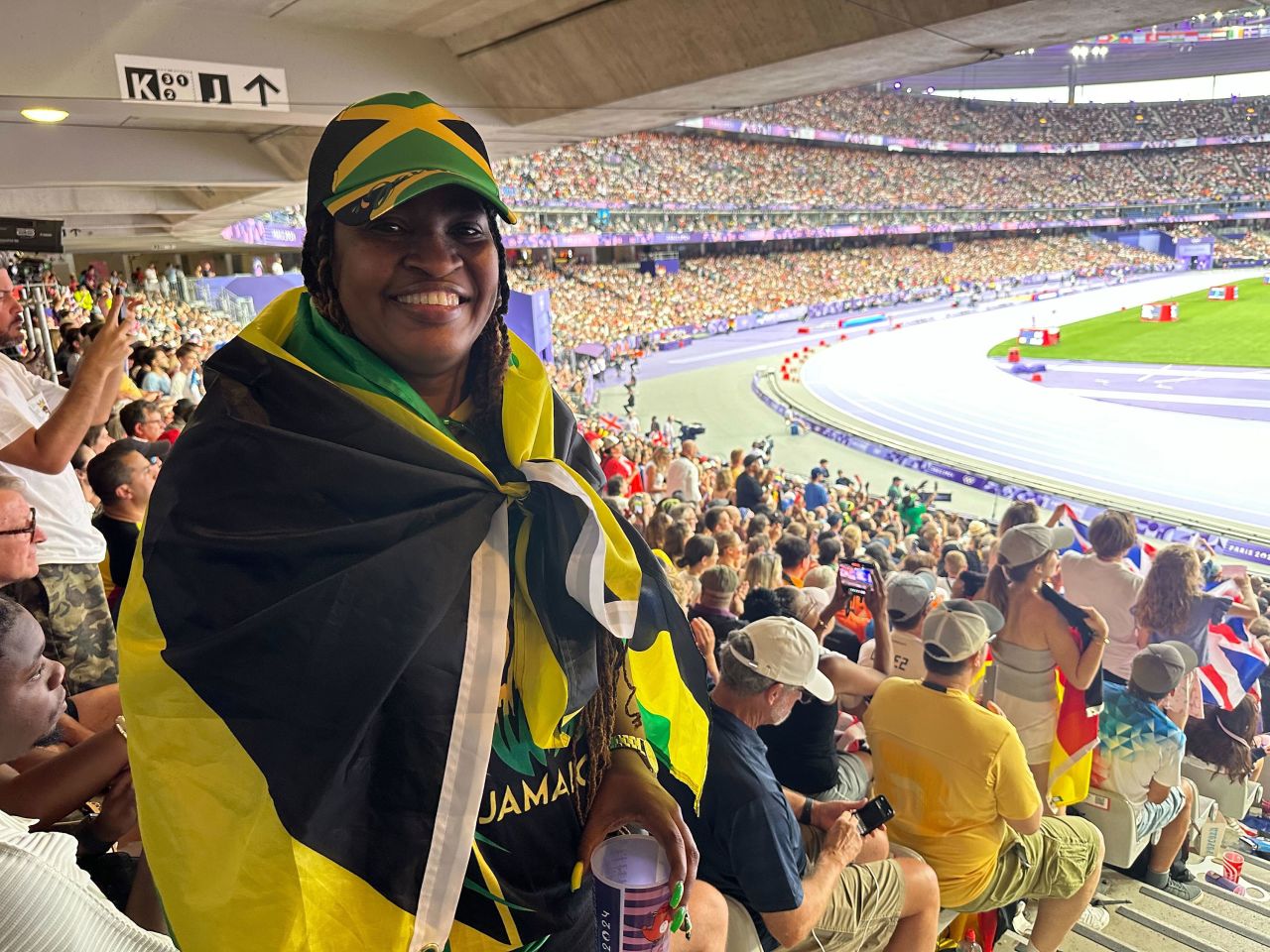 Michelle Vassell wears a Jamaican flag draped over her shoulders Saturday. 