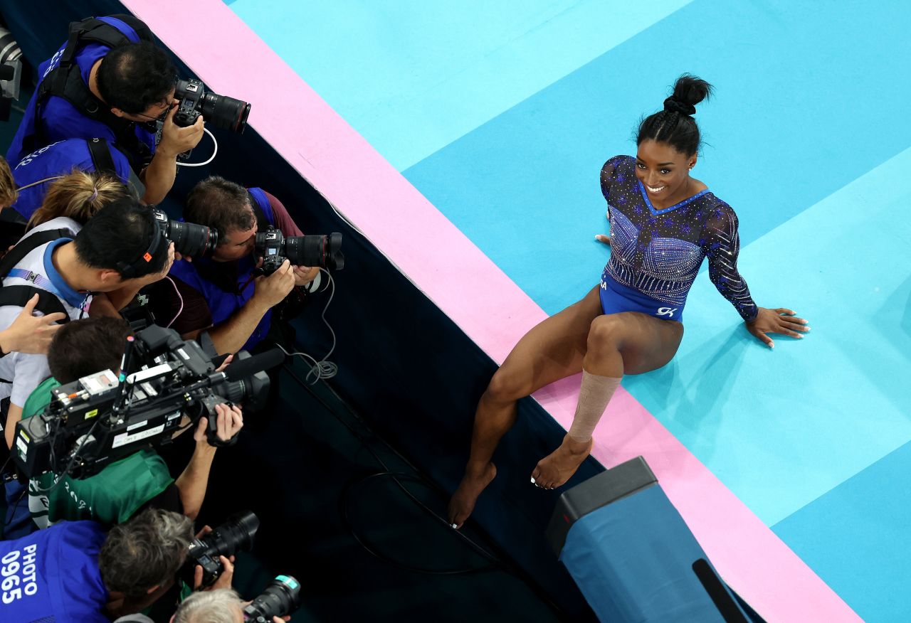 Gold medalist Simone Biles poses for photos on Thursday.