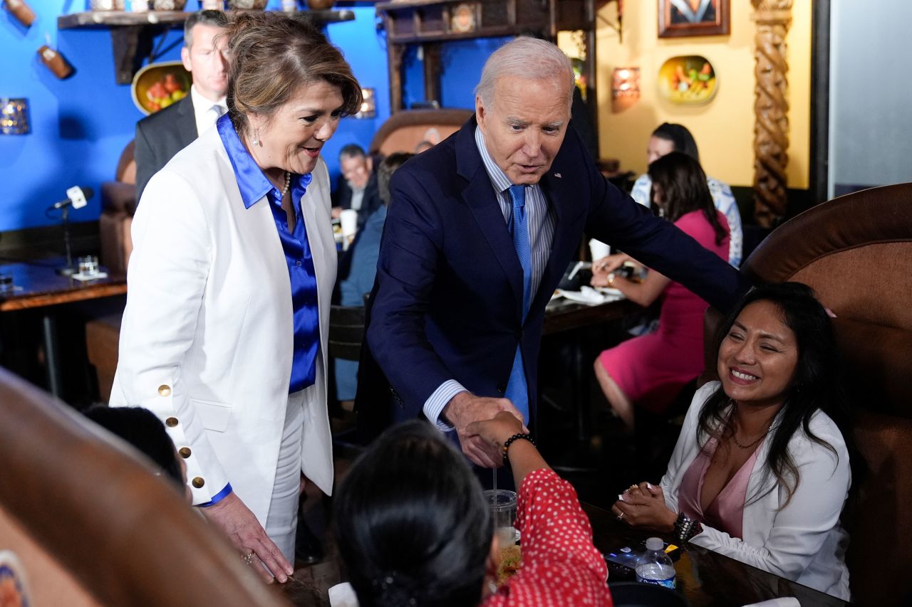 President Joe Biden and campaign adviser Maritza Rodriguez greet patrons at a restaurant during a stop in Las Vegas on Wednesday, hours before his Covid-19 diagnosis.