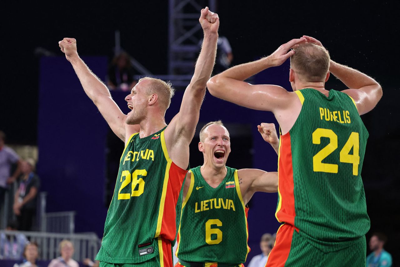 Lithuania's Evaldas Dziaugys, Gintautas Matulis and Aurelijus Pukelis celebrate winning the men's 3x3 basketball bronze medal against Latvia.