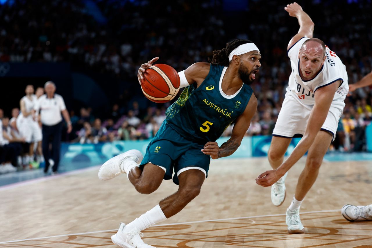 Australia's #05 Patty Mills outflanks Serbia's #27 Dejan Davidovac in the men's quarterfinal basketball match on August 6.