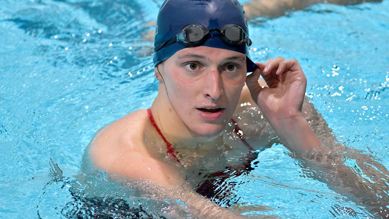 FILE - Transgender swimmer Lia Thomas speaks to her coach after winning the 500 meter freestyle during a meet with Harvard on Jan. 22, 2022, at Harvard University in Cambridge, Mass. Hardly a day passed in 2022 when a headline running across the ticker on ESPN would have been fitting on CNN or Fox Business. The intersection between sports and real life ranged from toxic workplace environments, alleged sexual misconduct, sportswashing, cryptocurrency, transgender sports and the COVID-19 pandemic. (AP Photo/Josh Reynolds, File)