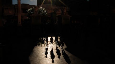 People walk in the sun along the Las Vegas Strip, in Las Vegas, Nevada, on July 7, 2024.