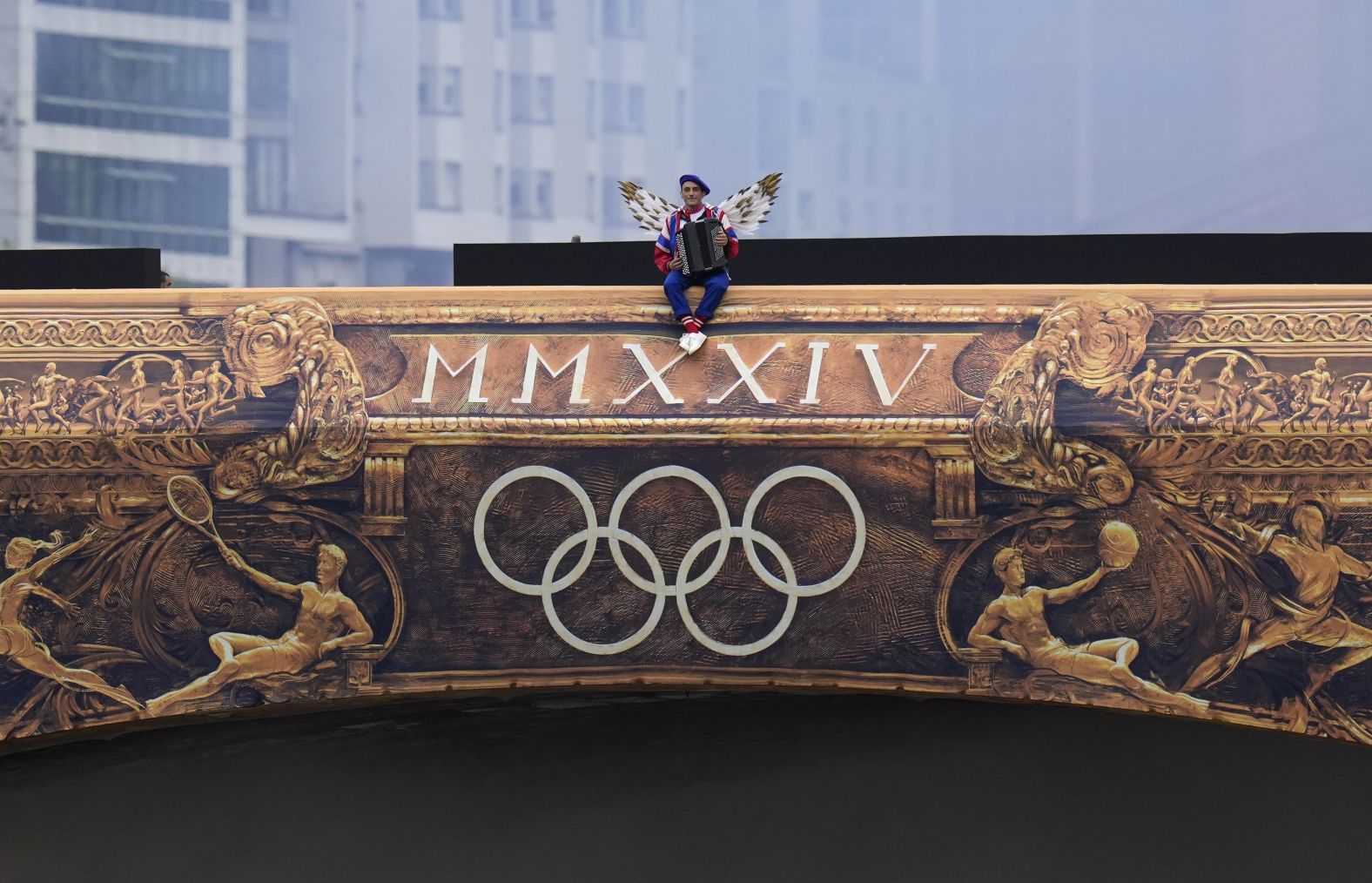 A performer sits on a bridge at the start of the ceremony.