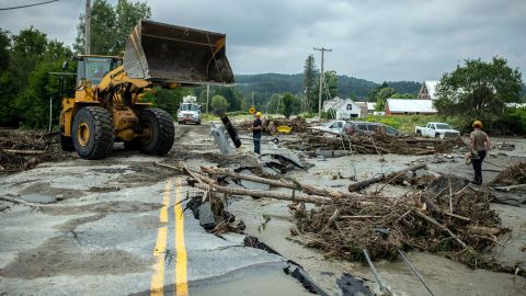 Workers clear debris amid flood damage in Lyndon, Vermont, on Tuesday, July 30.