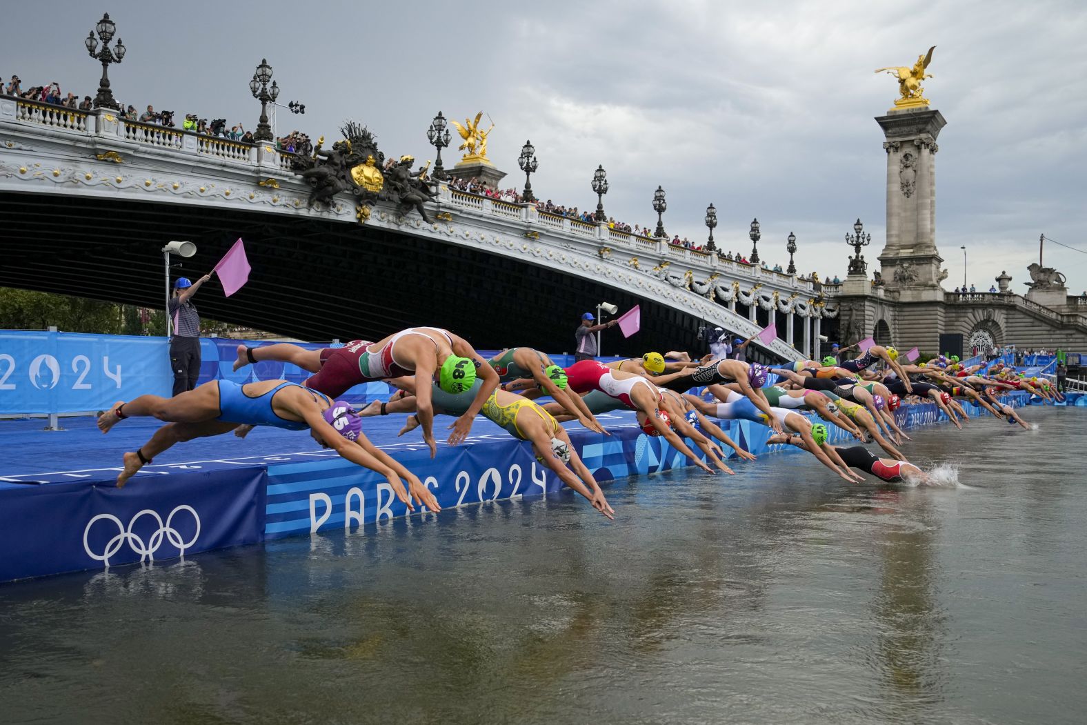 Competitors dive into the Seine River in Paris during the women's Olympic triathlon on July 31. <a href="https://www.cnn.com/2024/07/29/sport/seine-pollution-olympics-triathlon-postponed-intl-hnk/index.html"