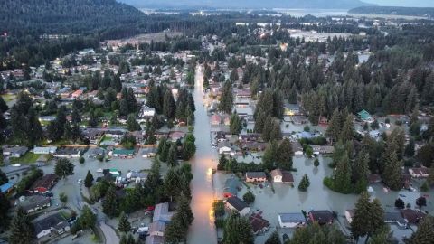 This image taken with a drone and provided by Richard Ross shows shows high water around homes and neighborhoods following an outburst of flooding from a lake dammed by the Mendenhall Glacier, Tuesday, Aug. 6, 2024, in Juneau, Alaska. (Richard Ross via AP)