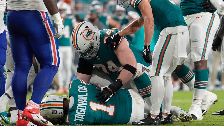 Miami Dolphins quarterback Tua Tagovailoa (1) lies on the field after suffering a concussion during the second half of an NFL football game against the Buffalo Bills, Thursday, September 12, 2024, in Miami Gardens, Florida.