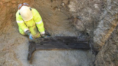 Archaeologist excavating the funerary bed