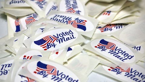 Stickers reading "I Voted By Mail" are displayed as the Wayne County Board of Elections prepares absentee ballots in Goldsboro, North Carolina, in September 2022.