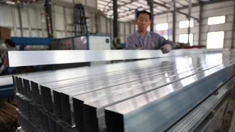 A worker is producing aluminum profile products at an aluminum profile production company in Binzhou, Shandong province, China, on June 5.