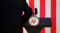 An aide attaches an official seal to the podium before US Vice President Kamala Harris attends a moderated conversation with former Trump administration national security official Olivia Troye and former Republican voter Amanda Stratton on July 17, 2024 in Kalamazoo, Michigan.