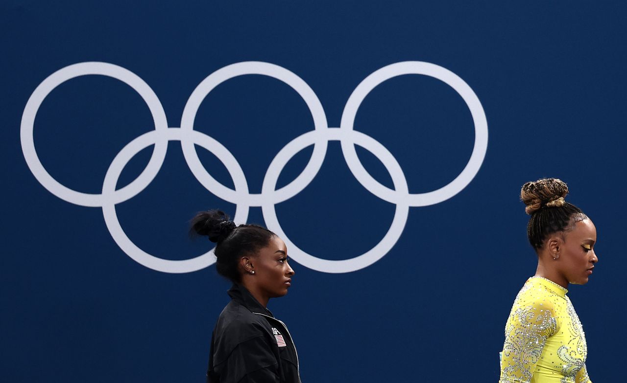 Simone Biles of Team United States and Rebeca Andrade of Team Brazil look on during the Artistic Gymnastics Women's All-Around Final on day six of the Olympic Games Paris 2024 at Bercy Arena on August 1.