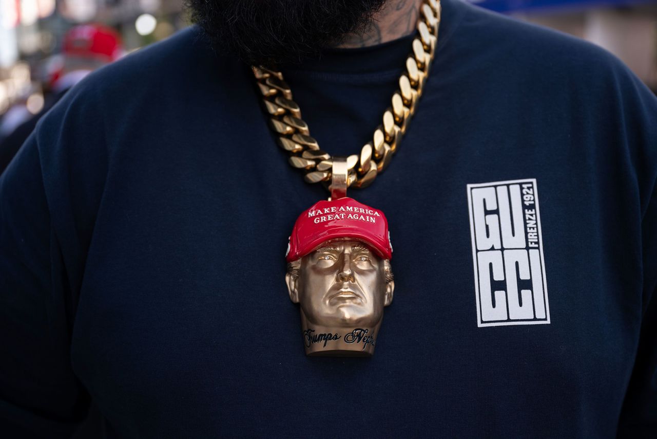 Rapper Forgiato Blow wears a Trump medallion around his neck on Thursday. 