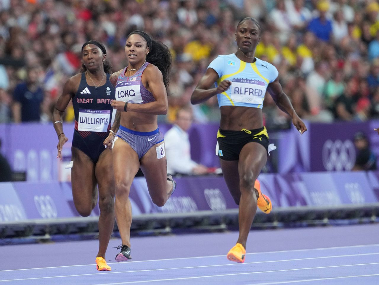 Julien Alfred races McKenzie Long and Bianca Williams in the women's 200m semifinals.