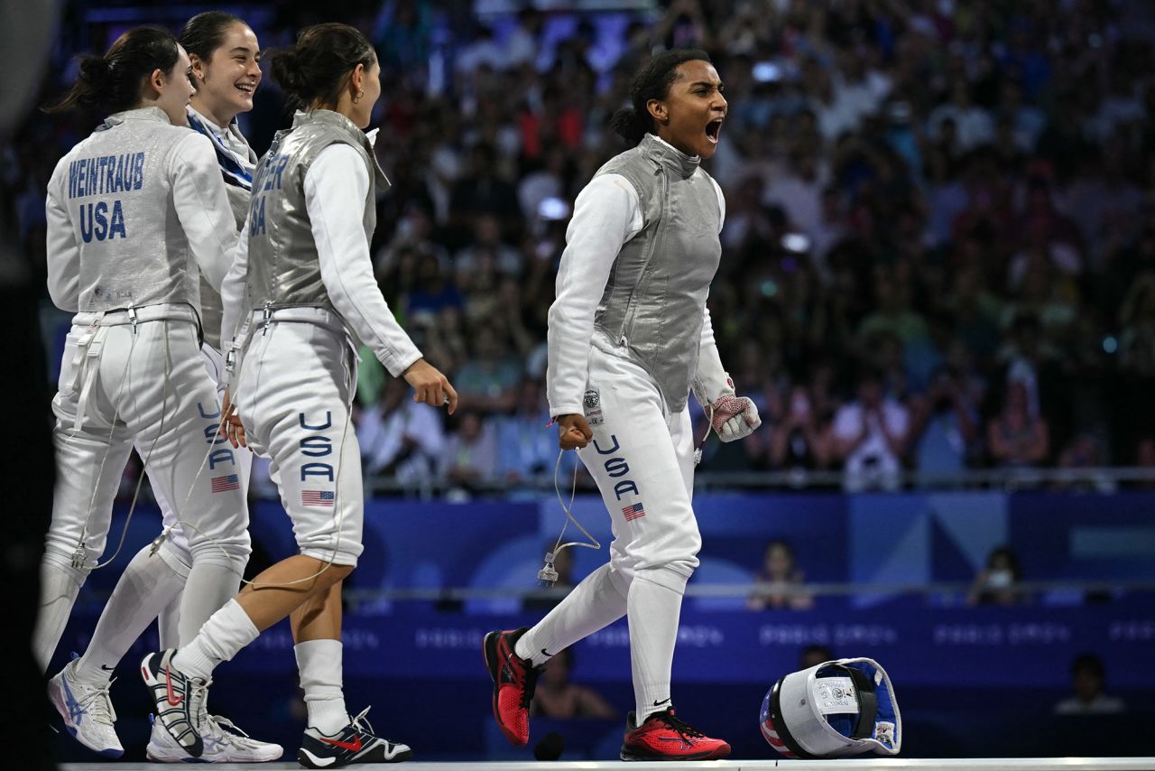 (From L) US' Maia Mei Weintraub, US' Jacqueline Dubrovich, US' Lee Kiefer and US' Lauren Scruggs celebrate after the women's foil team gold medal bout between Italy and USA at the Grand Palais in Paris today.