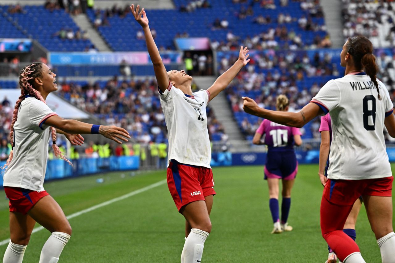 Sophia Smith, center, celebrates with teammates Trinity Rodman and Lynn Williams after beating Germany in Lyon, France, on August 6.