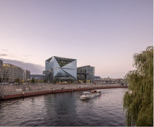 Cube Berlin, designed by 3XN as a futuristic office space, has a ventilated double-skin glass façade that helps reduce the amount of energy required to operate the building. It is located next to a central railway station, making it easy for workers to use public transport.