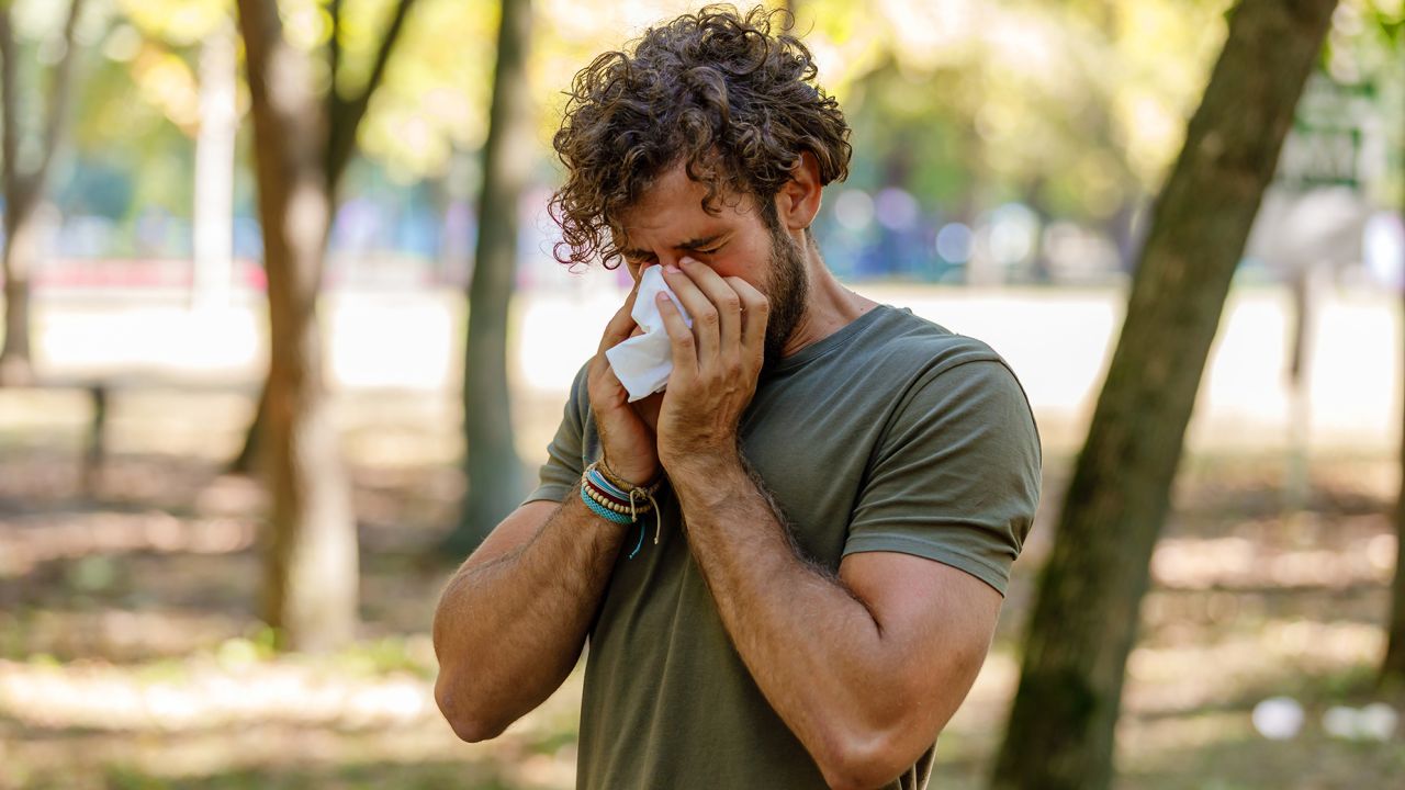 Sick Man With High Temperature is Using Handkerchiefs, Trying to Override the Sickness While Walking in Nature.