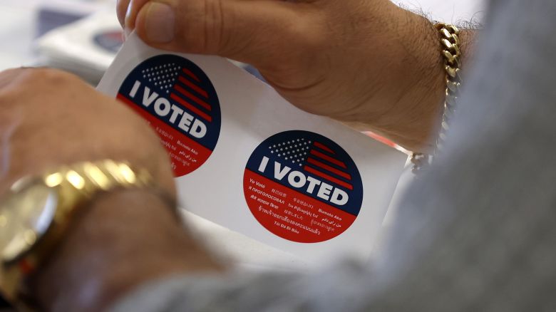 A polling station worker prepares to hand out 'I Voted' stickers on March 05, 2024 in Burbank, California. 15 States and one U.S. Territory hold their primary elections on Super Tuesday, awarding more delegates than any other day in the presidential nominating calendar.