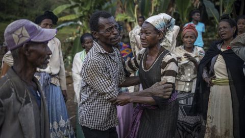 A man and a woman react while residents and volunteers leave for the night after digging in the mud in search for survivors and bodies at the scene of a landslide in Gofa on July 24, 2024. In tears, hugging each other, residents of Kencho Shacha Gozdi descend Wednesday evening, after a third day of desperate excavations, the hill where a landslide engulfed their loved ones in this rural and isolated area of southern Ethiopia .
The landslide, the deadliest so far publicly reported in Ethiopia, the second most populous country on the African continent (120 million inhabitants), left at least 229 dead. (Photo by Michele Spatari / AFP) (Photo by MICHELE SPATARI/AFP via Getty Images)