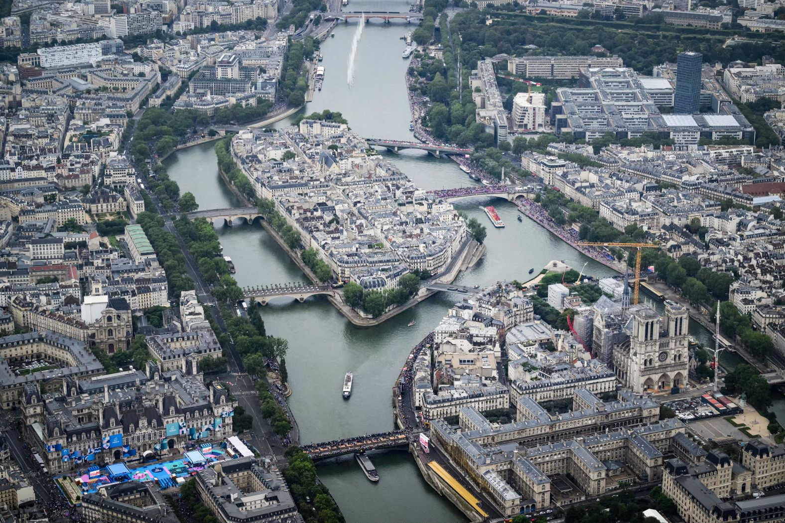 This aerial photo shows the Notre Dame cathedral as boats pass by on the Seine. As part of the opening ceremony, <a href="https://www.cnn.com/sport/live-news/paris-olympics-2024-opening-ceremony-seine#h_f4e1c79bb5cf9047ee74b7e7515bfe52"