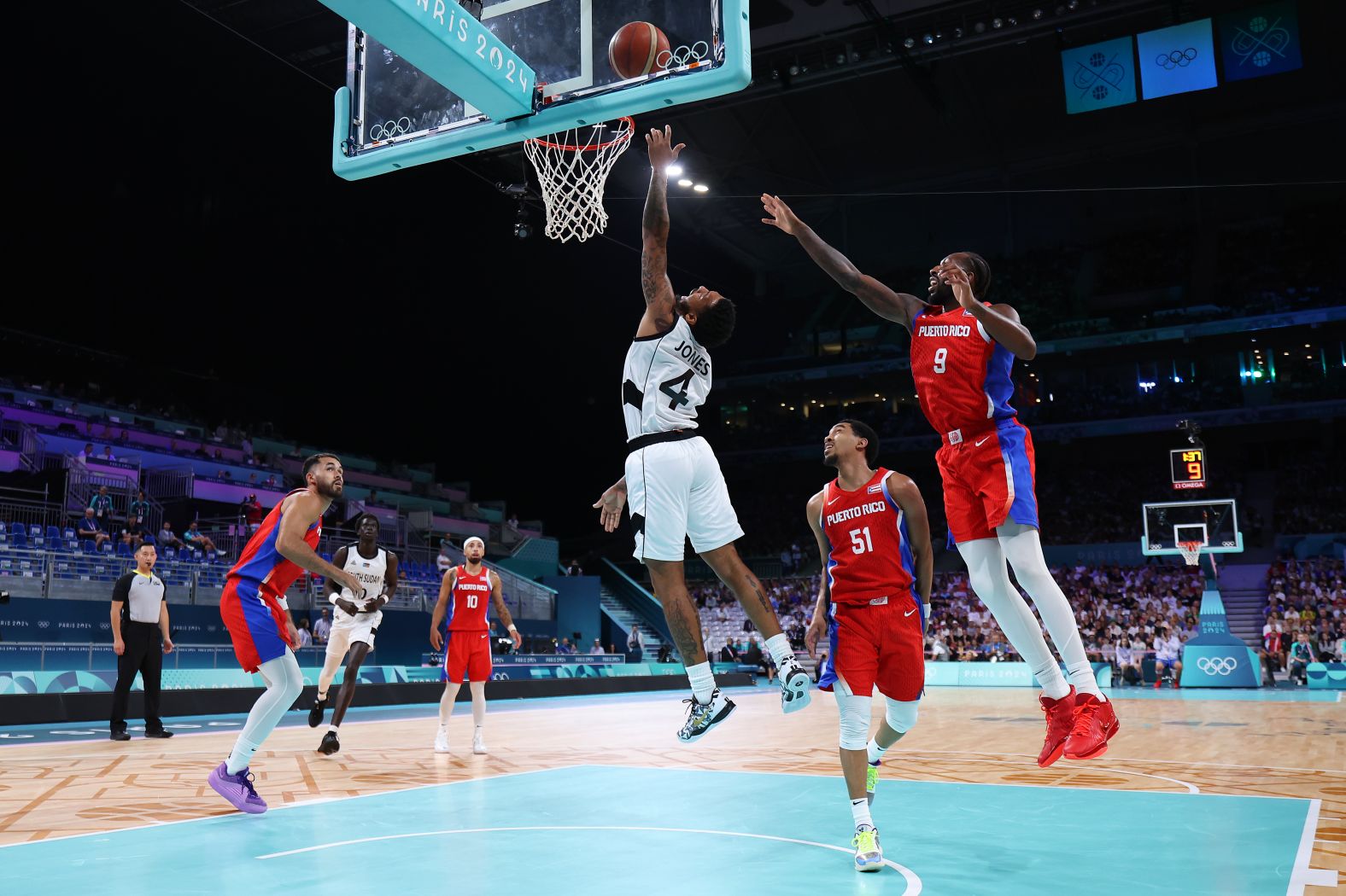 South Sudanese basketball player Carlik Jones drives to the basket during a game against Puerto Rico on July 28. South Sudan claimed a <a href="https://www.cnn.com/sport/live-news/paris-olympics-news-2024-07-28#h_c0270c5dd556a54f630fdf3c800a1bfd"