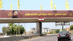 Yellow Hezbollah flags are erected along with a banner showing assassinated Hezbollah commander Fuad Shukr, along a walkway across the Sidon-to-Tyre highway, in southern Lebanon.