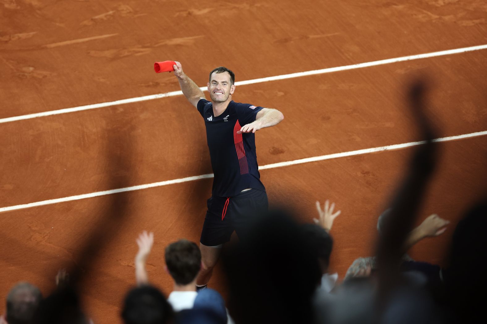 British tennis player Andy Murray throws his sweatband into the crowd after he and doubles partner Dan Evans <a href="https://www.cnn.com/sport/live-news/paris-olympics-news-2024-07-30#h_2282ca8d3cc57b451230e7eae1a6353f"