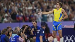 PARIS, FRANCE - AUGUST 05: Sweden's Armand Duplantis celebrates his victory with the famous shooting pose of Turkish Olympic silver medalist shooter Yusuf Dikec after passing 6.10m and setting the new Olympic record in the men's pole vault final of the athletics event at the Paris 2024 Olympic Games at Stade de France in Saint-Denis, north of Paris, on August 5, 2024. (Photo by Mustafa Ciftci/Anadolu via Getty Images)