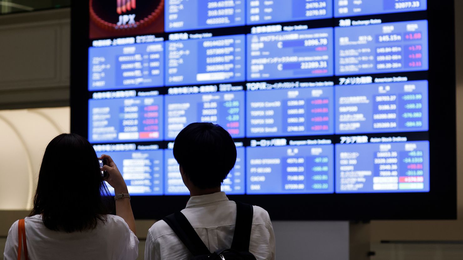 Visitors in front of a stock board at the Tokyo Stock Exchange, pictured on August 6, 2024.