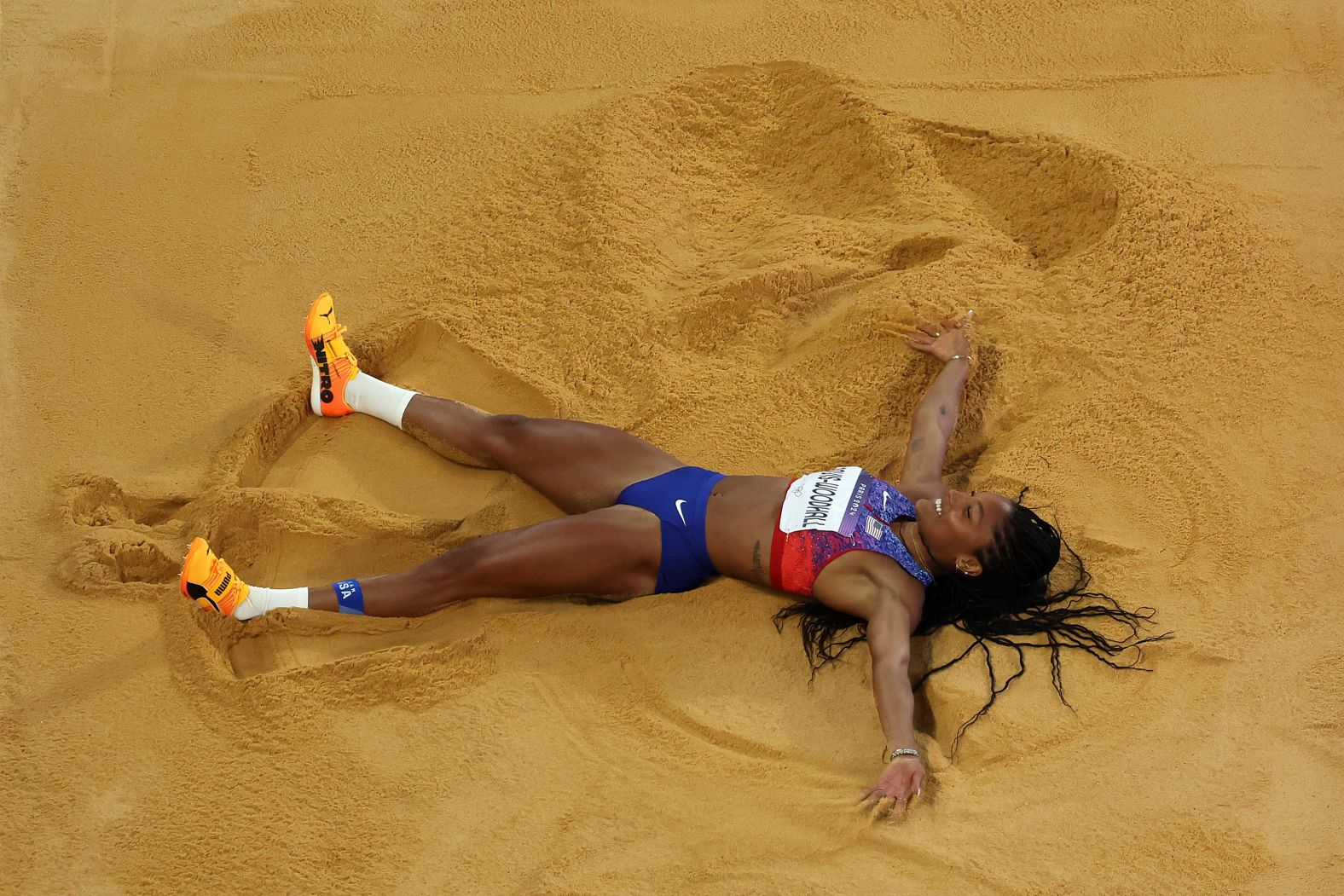 American long jumper Tara Davis-Woodhall celebrates in the sand <a href="https://www.cnn.com/sport/live-news/paris-olympics-news-2024-08-08#h_868d41b29914d80333e85fe5b69ae2b2"