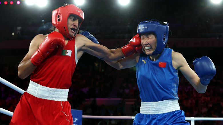 PARIS, FRANCE - AUGUST 09: Imane Khelif of Team Algeria punches Yang Liu of Team People's Republic of China during the Boxing Women's 66kg Final match on day fourteen of the Olympic Games Paris 2024 at Roland Garros on August 09, 2024 in Paris, France. (Photo by Richard Pelham/Getty Images)