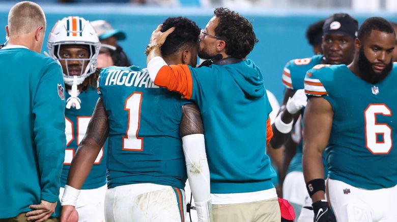 Miami Dolphins head coach Mike McDaniel embraces Tua Tagovailoa as he leaves the field after suffering a concussion against the Buffalo Bills.