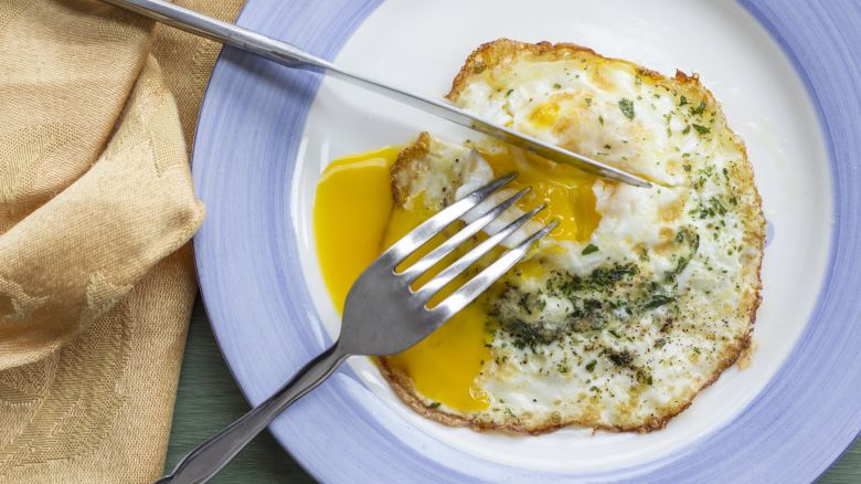 Fried runny egg over easy with salt pepper and parsley