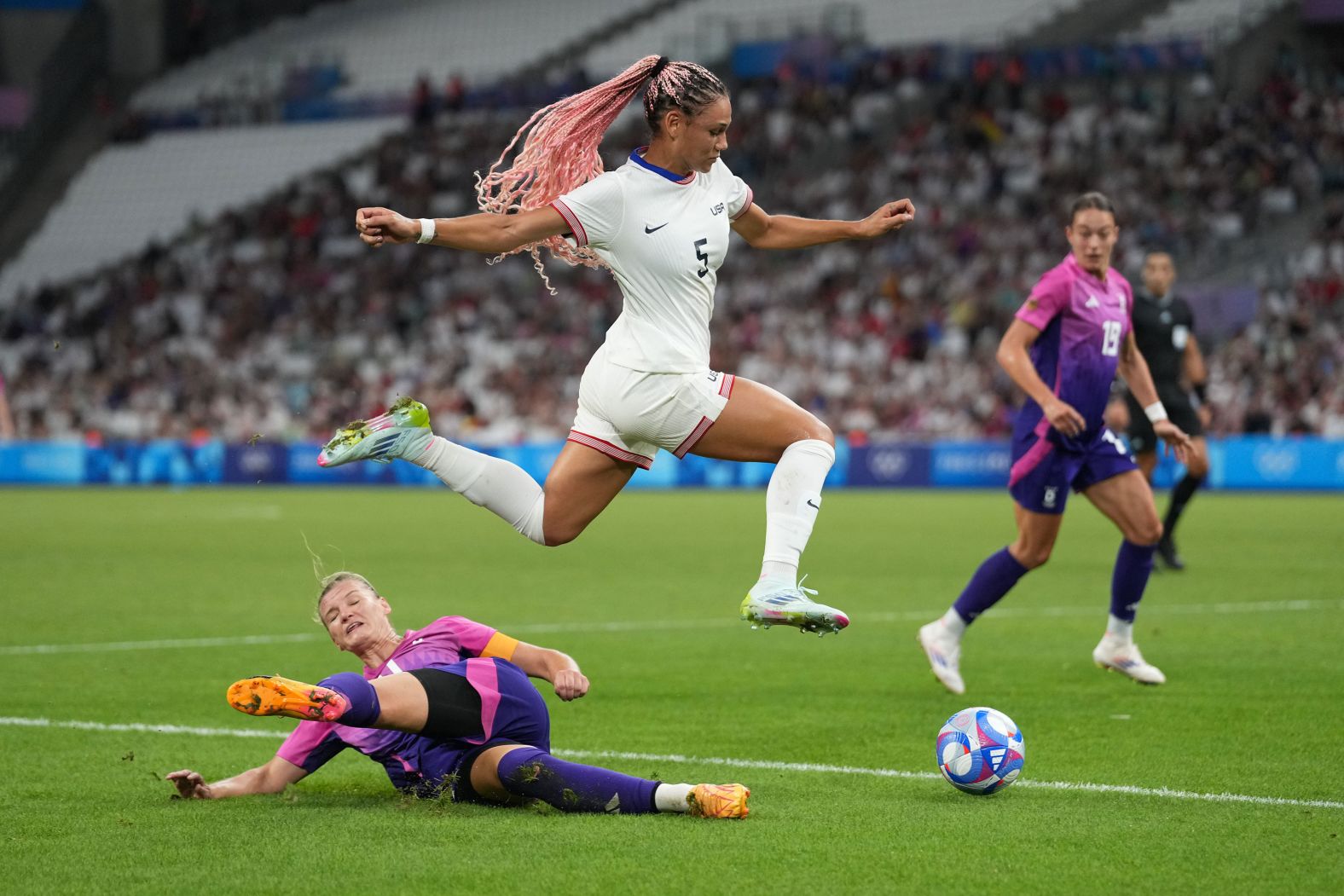 US forward Trinity Rodman jumps over Germany's Alexandra Popp during <a href="https://www.cnn.com/sport/live-news/paris-olympics-news-2024-07-28#h_120d2d453e327133d38d827ba7276d46"