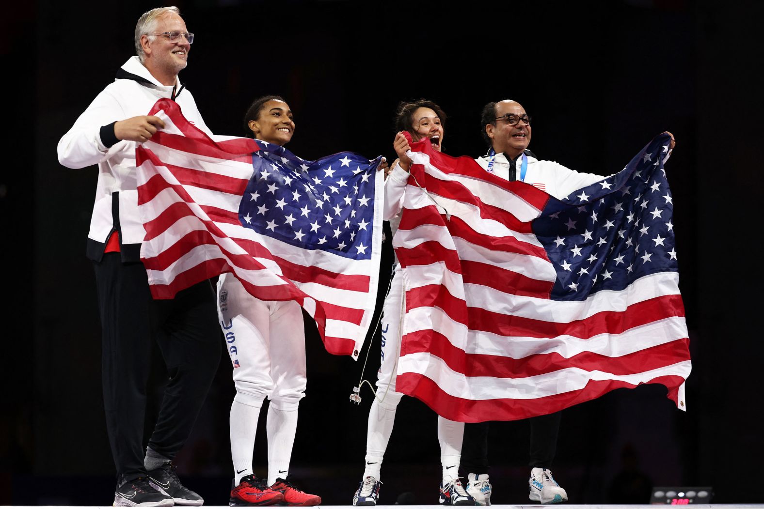 US fencers Lauren Scruggs, center left, and Lee Kiefer celebrate after facing off in the foil final on July 28. <a href="https://www.cnn.com/sport/live-news/paris-olympics-news-2024-07-28#h_a5ef3047654247f764f7f57ca714fe53"