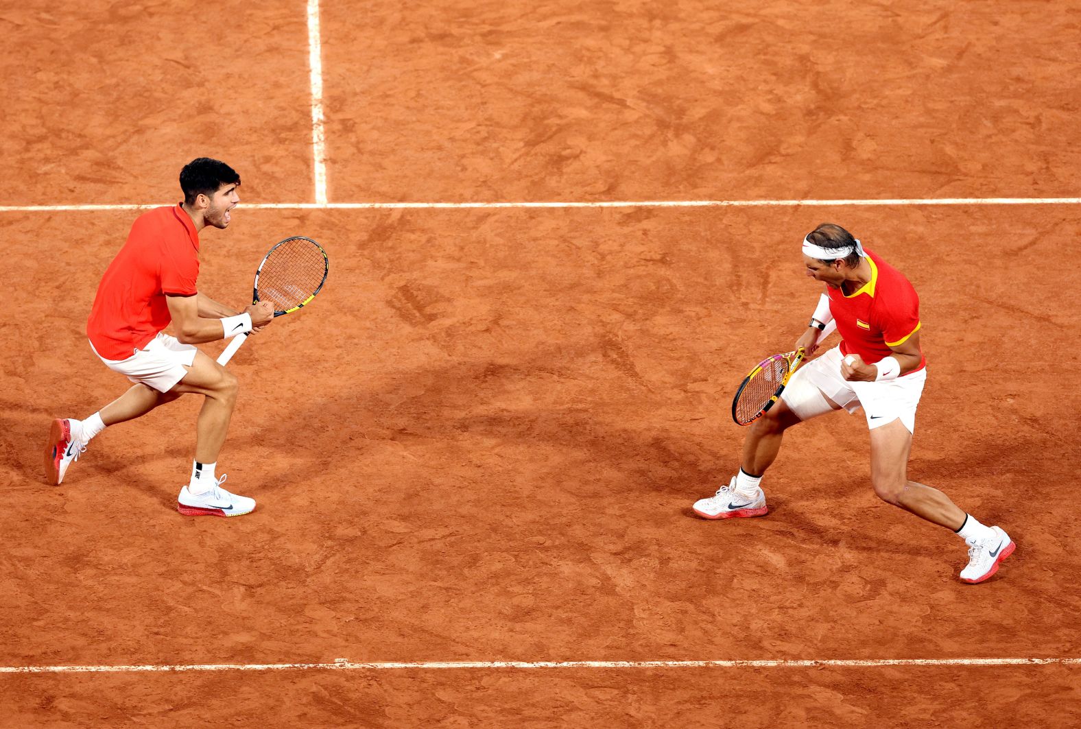 Spanish tennis players Carlos Alcaraz and Rafael Nadal celebrate during a doubles match on July 27. <a href="https://www.cnn.com/2024/07/27/sport/rafael-nadal-carlos-alcaraz-paris-olympics-tennis-spt-intl/index.html"