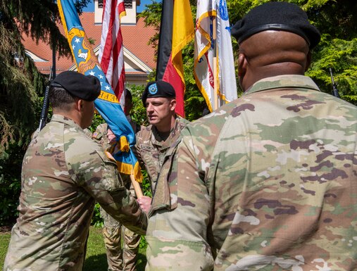 military officers pass flag in ceremony