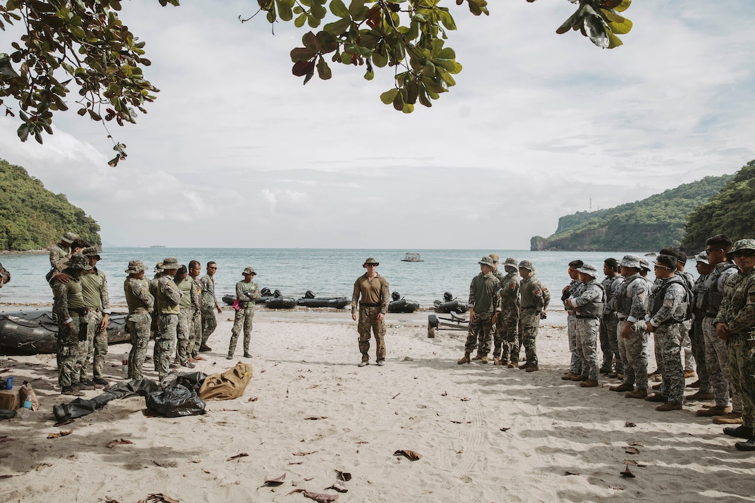 A U.S. Marine, center, assigned to 15th Marine Expeditionary Unit, gives a safety brief to Philippine Marines and special operations forces coast guardsmen, and Republic of Korea special reconnaissance Marines before combat rubber raiding craft training as part of exercise KAMANDAG 8 in Philippines, Oct. 20, 2024. KAMANDAG is an annual Philippine Marine Corps and U.S. Marine Corps-led exercise aimed at enhancing the Armed Forces of the Philippines’ defense and humanitarian capabilities by providing training in combined operations with foreign militaries in the advancement of a Free and Open Indo-Pacific.